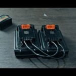 A Black and Decker 20v battery and charger displayed on a modern workbench.