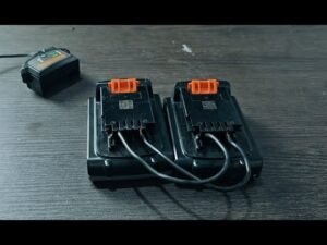 A Black and Decker 20v battery and charger displayed on a modern workbench.