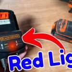 A Black and Decker battery charger sits on a workbench waiting for a battery.