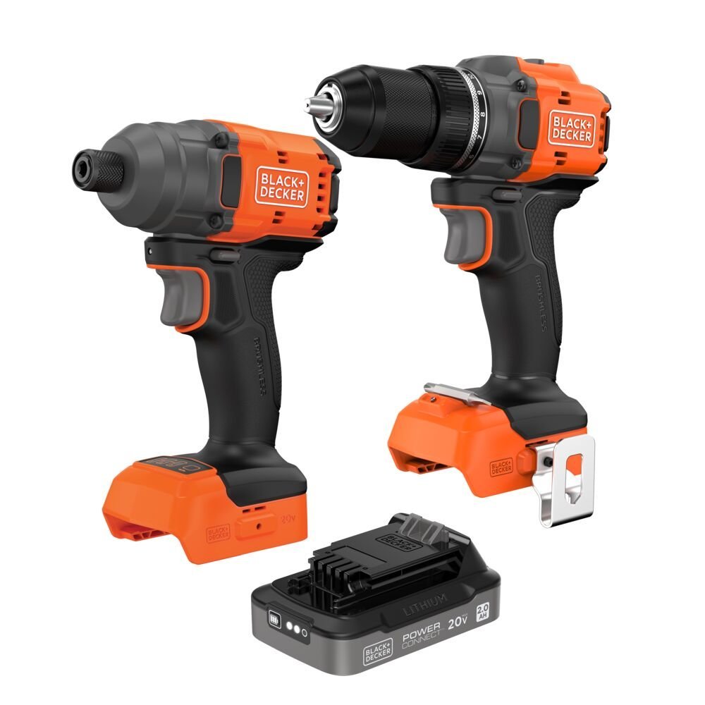 Cleaning the trigger of a cordless drill with compressed air in a workshop.