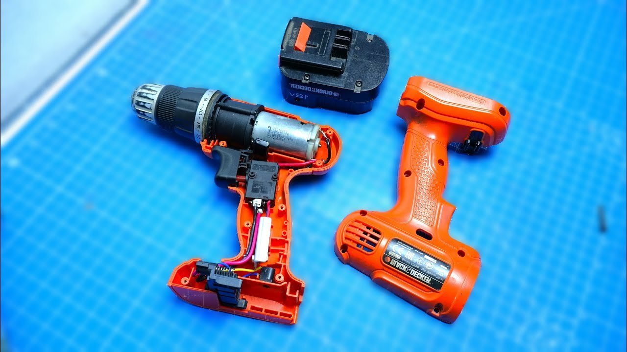 A cordless drill battery being tested with a multimeter on a white surface.