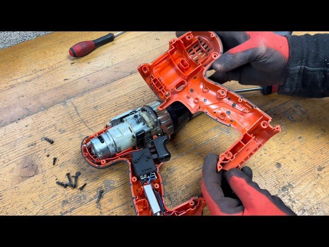 Internal mechanical components of a power drill motor showing detailed copper wiring.