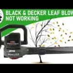 A Black and Decker electric leaf blower sits on a clean garage floor.