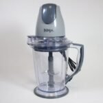 A disassembled Ninja blender sits on a clean kitchen counter for troubleshooting.