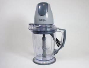 A disassembled Ninja blender sits on a clean kitchen counter for troubleshooting.