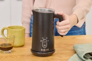 An electric milk frother sits on a kitchen counter during the morning.