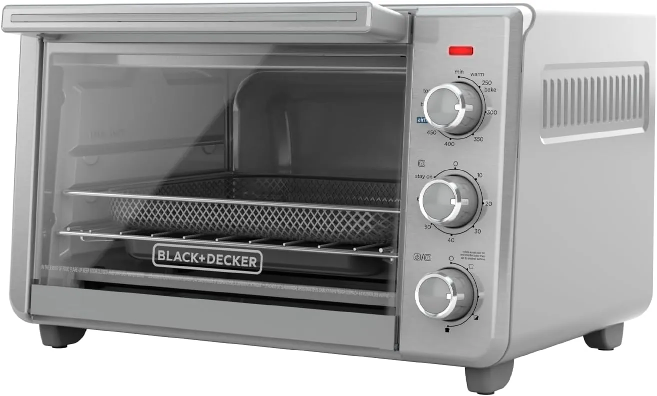 A hand firmly inserting the basket into a black air fryer unit.