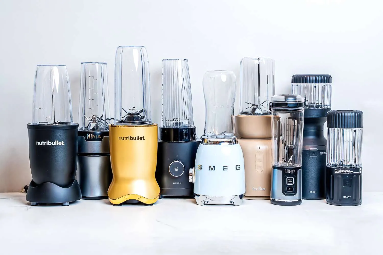 Hands aligning the magnetic safety sensor on a portable blender base and jar.