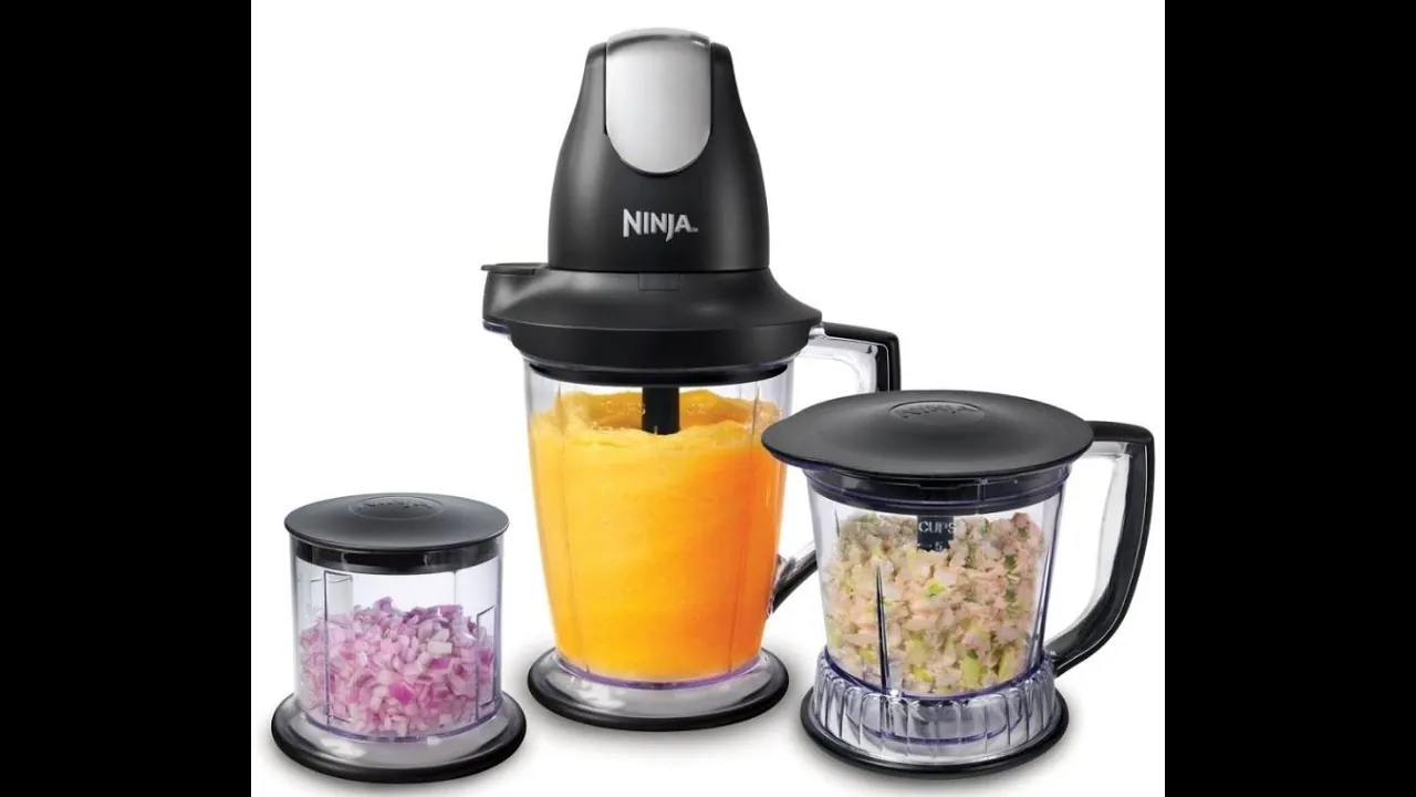 Hands firmly locking a Ninja blender lid to engage the safety switch.