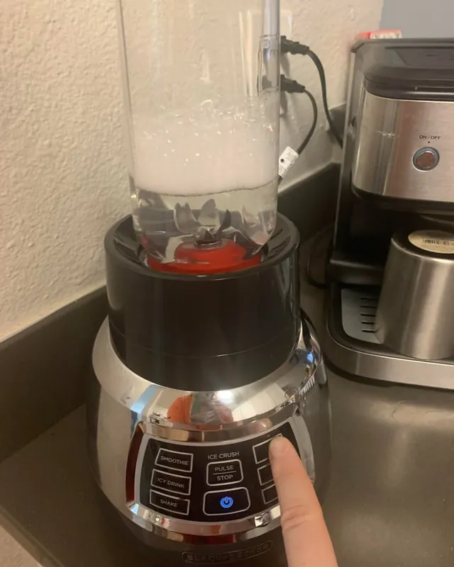 The internal safety mechanism and reset button of a kitchen blender base.