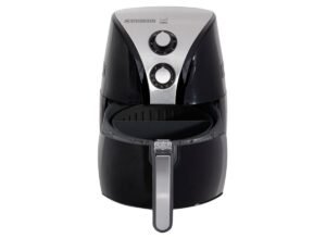 A modern black air fryer sitting on a clean kitchen countertop.