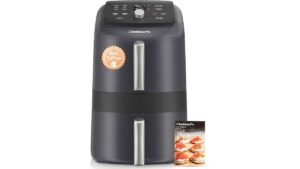A modern black air fryer sitting on a clean white kitchen countertop.