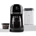 A modern coffee maker on a marble countertop representing common appliance troubleshooting issues.