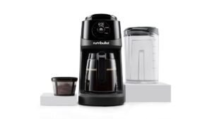 A modern coffee maker on a marble countertop representing common appliance troubleshooting issues.