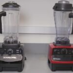 A modern kitchen blender disassembled on a marble countertop for troubleshooting.