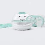 A modern NutriBullet baby steamer placed on a bright kitchen counter for food preparation.