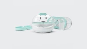 A modern NutriBullet baby steamer placed on a bright kitchen counter for food preparation.