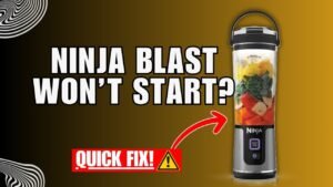 A modern portable blender sits on a counter with fresh fruit ingredients nearby.