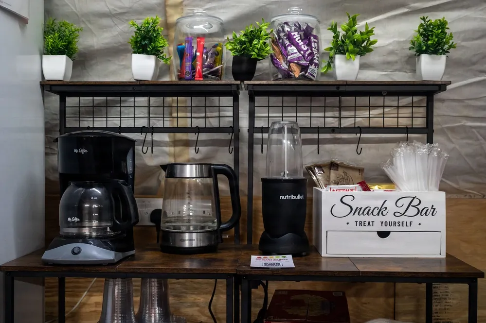 A person correctly seating the water reservoir into a coffee maker to ensure functionality.