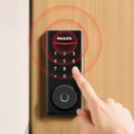 A modern smart door lock installed on a sleek wooden front door.