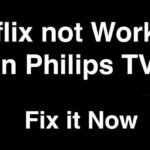 A modern Philips smart television displaying a loading screen in a living room.