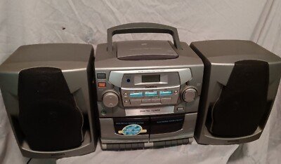 A Philips radio positioned near a window with its antenna extended for reception.