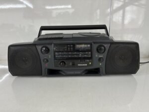 A vintage Philips radio sits on a wooden table in a bright room.