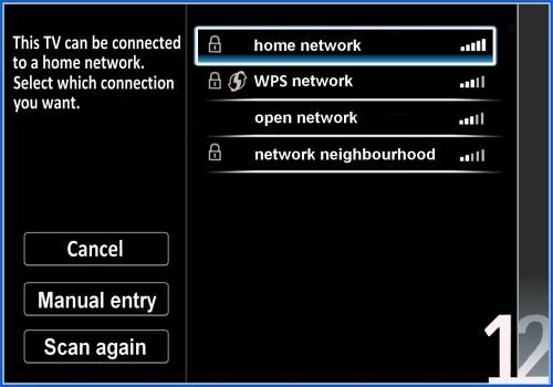A home network router showing active lights with a blurred television in back.
