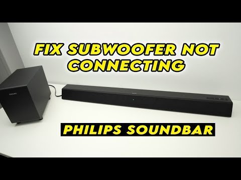 Technical troubleshooting tools and a smartphone for fixing a Philips sound bar subwoofer.