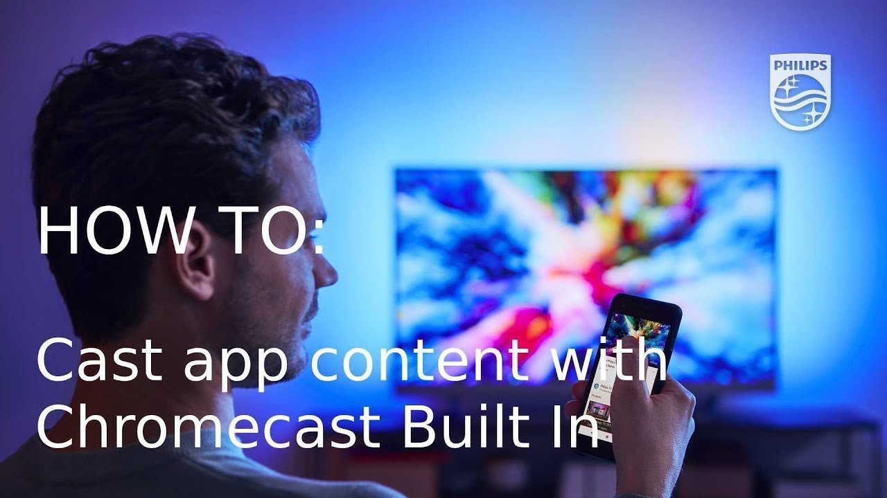 A person using a smartphone to attempt casting to a large television screen.