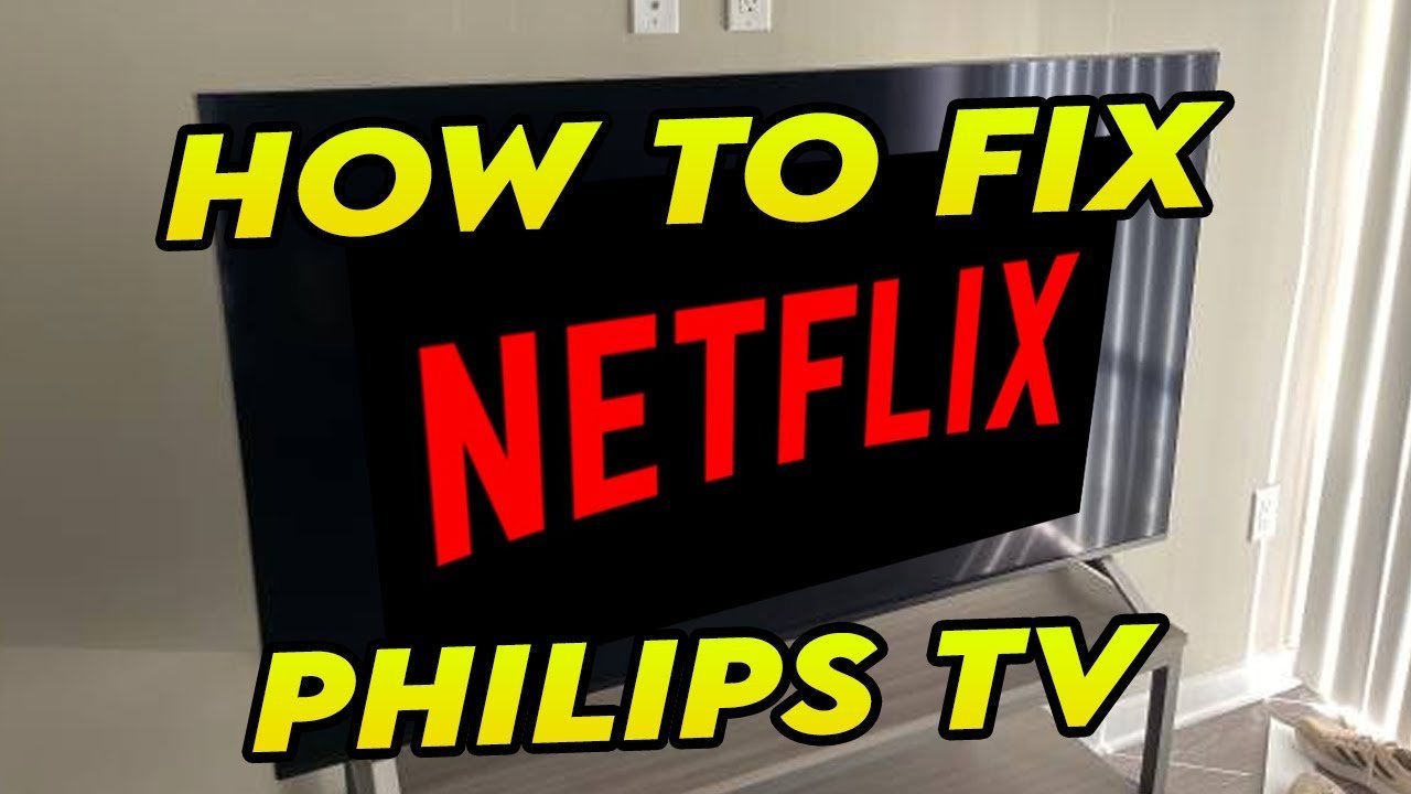 A TV remote lies on a sofa near a Philips TV showing an error.