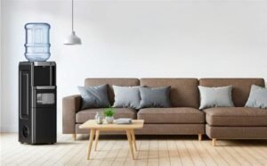 A portable space heater unplugged on a hardwood floor in a living room.