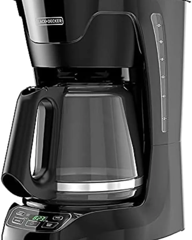 Pouring a vinegar and water solution into a coffee machine reservoir.