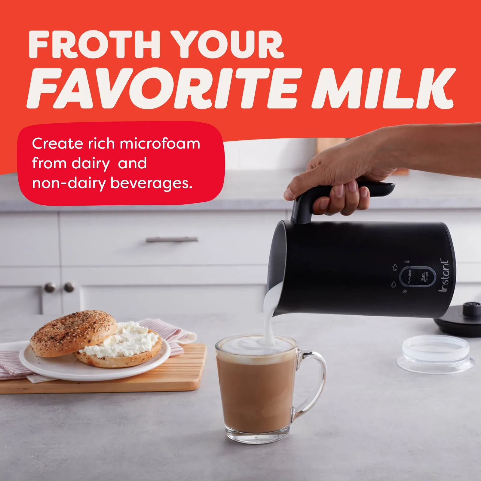 Rinsing a milk frother pitcher under a kitchen faucet to prevent buildup.