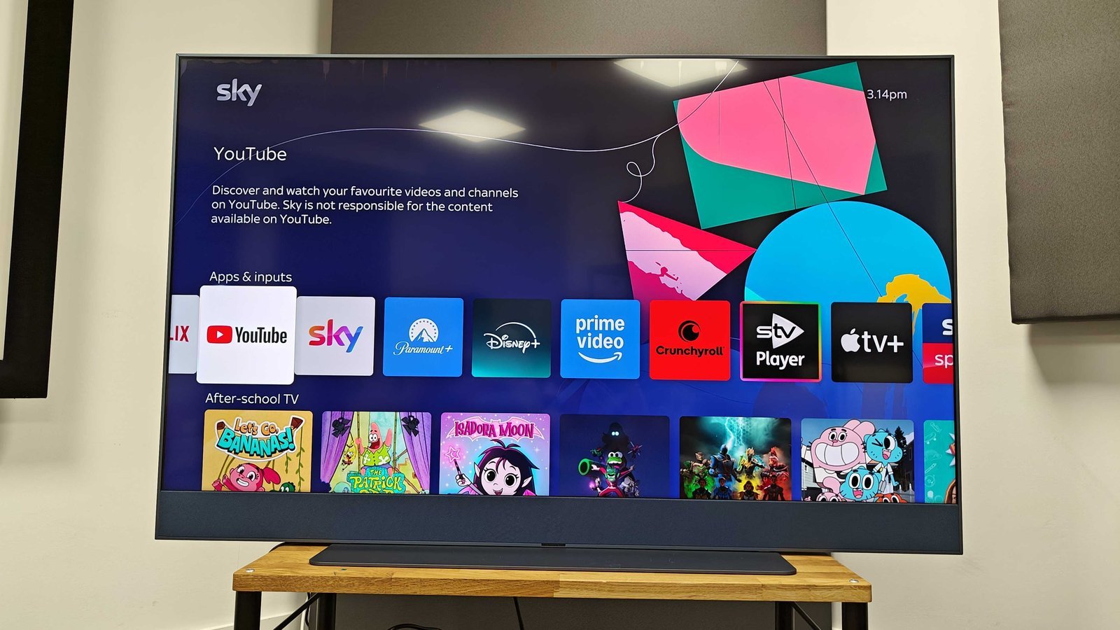 A user navigating the system settings menu on a Philips television to update software.